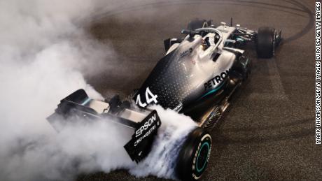 Lewis Hamilton celebrates his win with donuts on track.