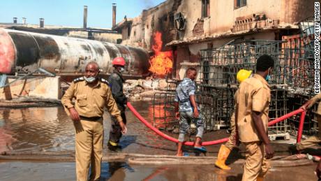 Members of the Sudanese Civil Defense put out the fire at a factory unit in northern Khartoum.