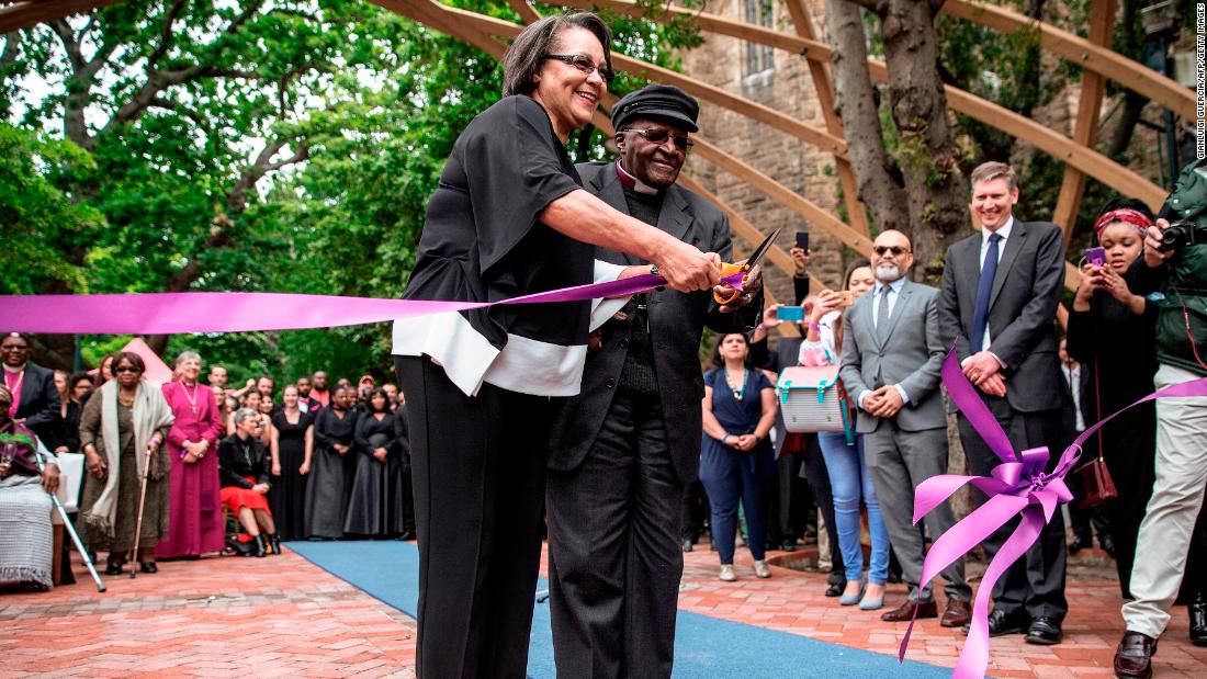Tutu, accompanied by Cape Town Mayor Patricia de Lille, cuts a ribbon to unveil the &quot;Arch for the Arch&quot; in 2017. The architectural structure commemorates Tutu&#39;s life and work and also represents the 14 chapters of the South African constitution.
