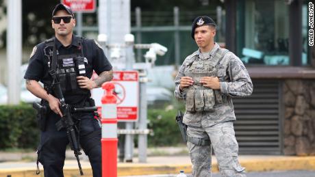 Security stands guard outside the main gate at Joint Base Pearl Harbor-Hickam, in Hawaii.