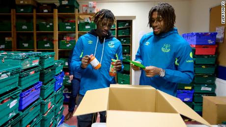 Moise Kean and Alex Iwobi help sort stock at North Liverpool food bank.