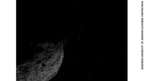 Particles can be seen releasing from the asteroid.