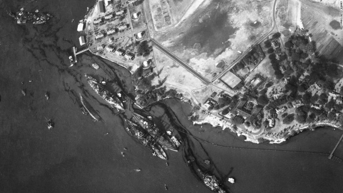 An aerial view of the harbor shows the destruction of the USS California, the USS Maryland, the USS Oklahoma, the USS Tennessee, the USS West Virginia and the USS Arizona.