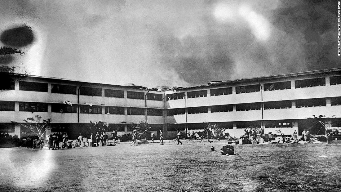 A fire spreads through the Army barracks at Hickam Field.