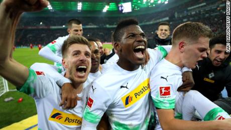 Borussia Monchengladbach players celebrate victory against Bayern Munich.