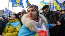 Protesters draped in Ukrainian flags rally against Zelensky&#39;s Donbas peace plan.