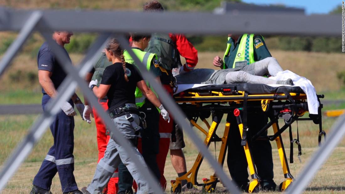 Emergency services attend to a person injured in the eruption, after arriving at the Whakatane Airfield.