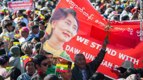 People rally in support of Myanmar State Counsellor Aung San Suu Kyi in Yangon ahead of her appearance at the International Court of Justice.