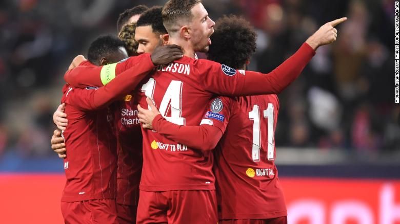 Naby Keita of Liverpool celebrates with Jordan Henderson and team mates after he scores during the 2-0 win at Salzburg.