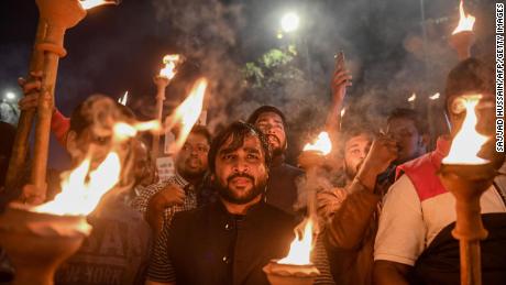 Demonstrators hold torches as they shout slogans against the government&#39;s Citizenship Amendment Bill (CAB), during a protest in New Delhi on December 11, 2019. 