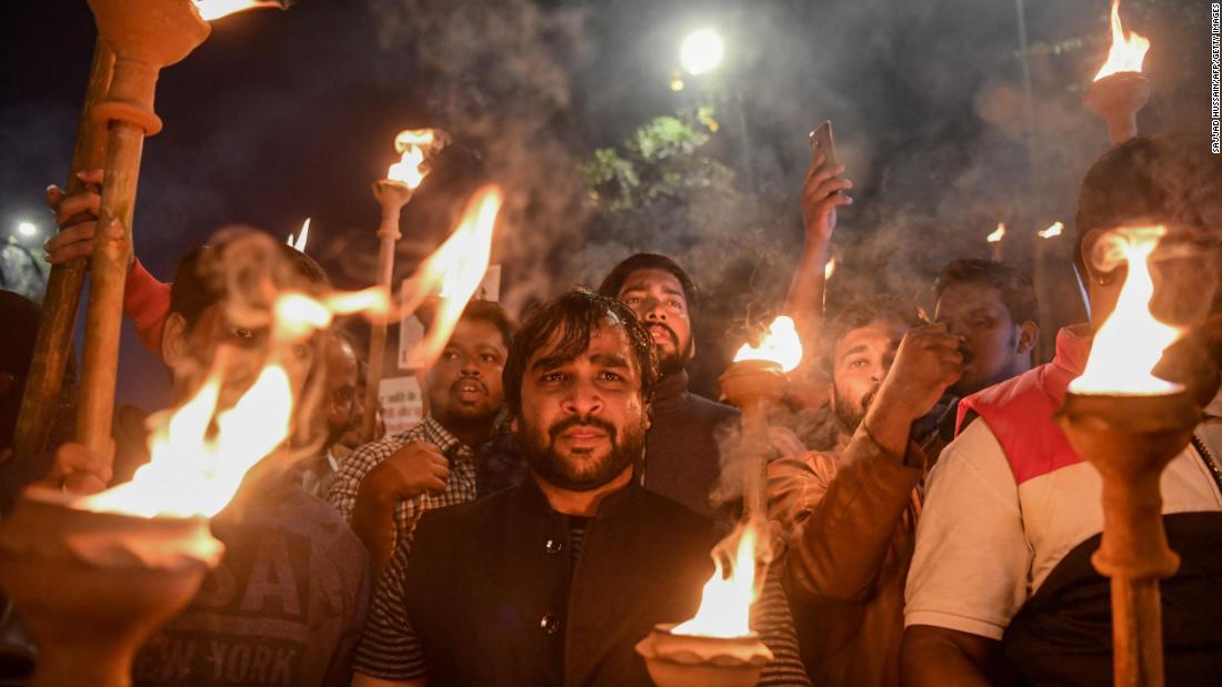 Indian youth congress members hold torches as they demonstrate in New Delhi on Wednesday, December 11.