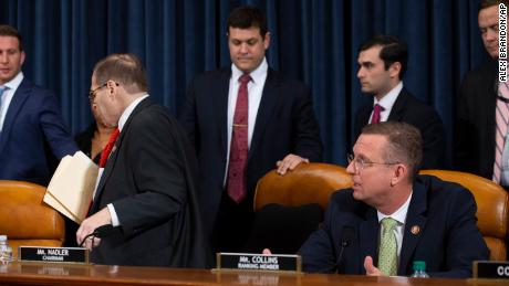 House Judiciary Committee Chairman Rep. Jerrold Nadler, D-N.Y., left, leaves as ranking member Rep. Doug Collins, R-Ga., seated right, speaks after adjournment following a marathon debate during a markup of the articles of impeachment against President Donald Trump, on Capitol Hill, Thursday, Dec. 12, 2019, in Washington. The House Judiciary Committee abruptly postponed a historic vote, shutting down a divisive 14-hour session that dragged with sharp partisan divisions but has been expected to end with the charges being sent to the full House for a vote next week. (AP Photo/Alex Brandon)