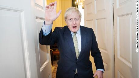 LONDON, ENGLAND - DECEMBER 13: Prime Minister Boris Johnson arrives back at 10 Downing Street after visiting Buckingham Palace where he was given permission to form the next government during an audience with Queen Elizabeth II on December 13, 2019 in London, England. The Conservative Party have realised a decisive win in the UK General Election. With one seat left to declare they have won 364 of the 650 seats available. Prime Minister Boris Johnson called the first UK winter election for nearly a century in an attempt to gain a working majority to break the parliamentary deadlock over Brexit. working majority to break the parliamentary deadlock over Brexit. He said at an early morning press conference that he would repay the trust of voters. (Photo by Stefan Rousseau - WPA Pool/Getty Images)