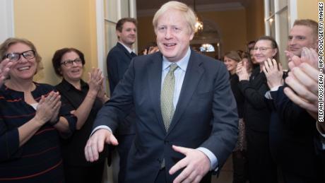 Boris Johnson is greeted by staff as he arrives back at 10 Downing Street after winning the 2019 general election.