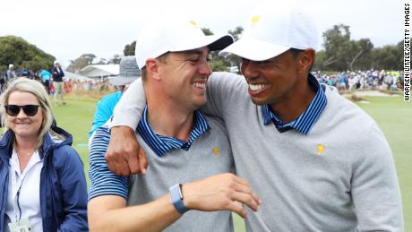 Tiger Woods (right) and Justin Thomas celebrate after winning their second match in Melbourne. 