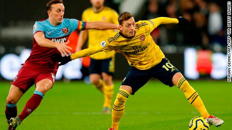 Mesut Ozil (L) in action for Arsenal against West Ham on December 9.