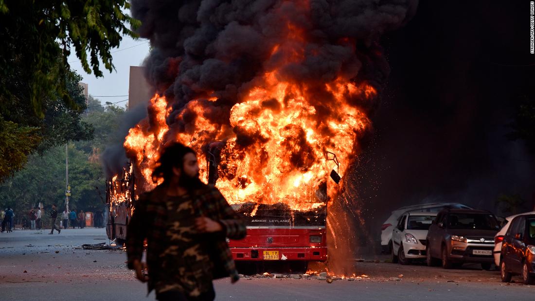 A bus is seen on fire following a demonstration in New Delhi on Sunday, December 15.