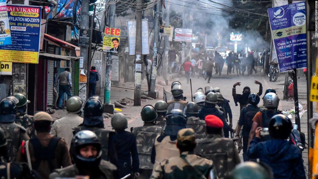 Police fire tear gas during a protest in Guwahati on Thursday, December 12.