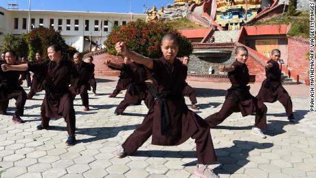 Nepali Buddhist nuns practise kung fu at the Amitabha Drukpa Nunnery on the outskirts of Kathmandu on December 21, 2017.