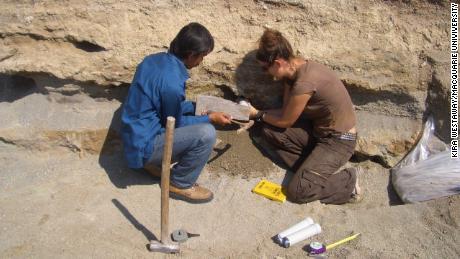 Kira Westaway and Iwan Kurniawan collect a sediment sample for dating from the Sembungan terrace excavation.