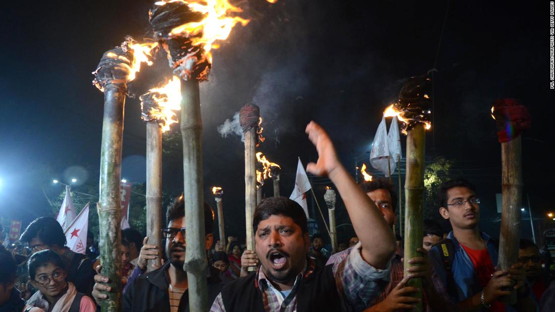 Protestors participate in a torch rally in Kolkata on December 17.