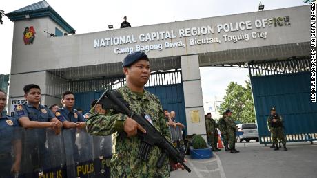 Members of the police special action force stand guard at a gate of the capital command headquarters in Manila on December 19, 2019.