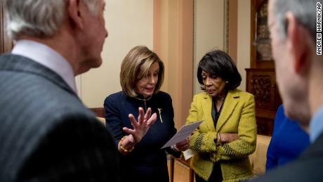 House Speaker Nancy Pelosi of Calif., center left, accompanied by House Ways and Means Committee Chairman Richard Neal, D-Mass., left, House Financial Services Committee Chairwoman Maxine Waters, D-Calif., right, and others, reviews her speech notes in a private room just off the House floor after the House votes to impeach President Donald Trump, Wednesday, Dec. 18, 2019, on Capitol Hill in Washington.