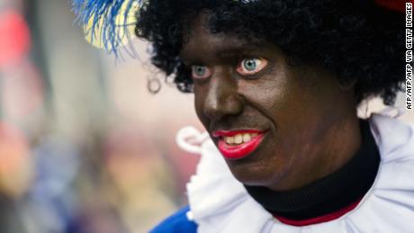  A woman dressed as Zwarte Piet (Black Piet) takes part in the arrival of Sinterklaas (Saint Nicolas) during the traditional move-in &#39;Intocht Sinterklaas&#39; event in Groningen, Netherlands, on November16,  2013. Zwarte Piet is the companion of Saint Nicolas during a yearly feast celebrated on the evening of 5 December. It was announced in October 2013 that the United Nations, under the authority of the High Commissioner for Human Rights, were to investigate whether Zwarte Piet is a racist stereotype. AFP PHOTO/ANP REMKO DE WAAL netherlands out         (Photo credit should read REMKO DE WAAL/AFP via Getty Images)