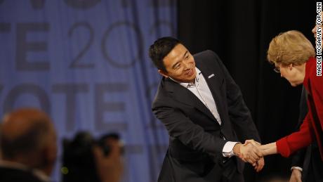 Andrew Yang shakes hands with Elizabeth Warren before the Democratic debate in Los Angeles on Thursday, December 19.