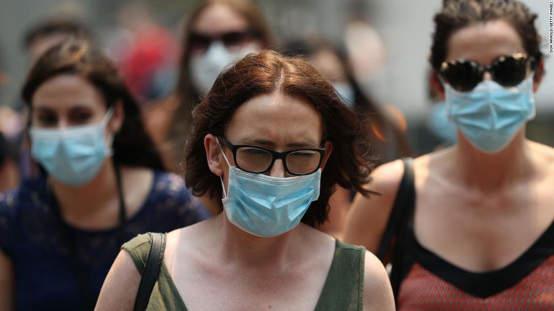 People are seen wearing face masks to protect against the poor air quality in Sydney on December 5.