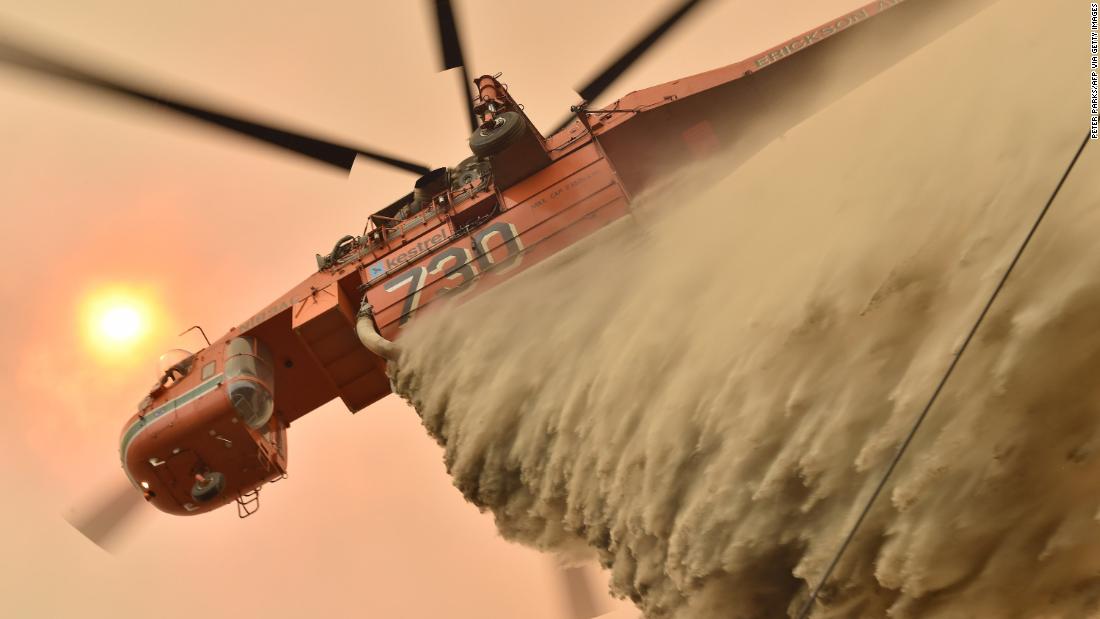 A helicopter drops fire-retardant to protect a property in Balmoral.