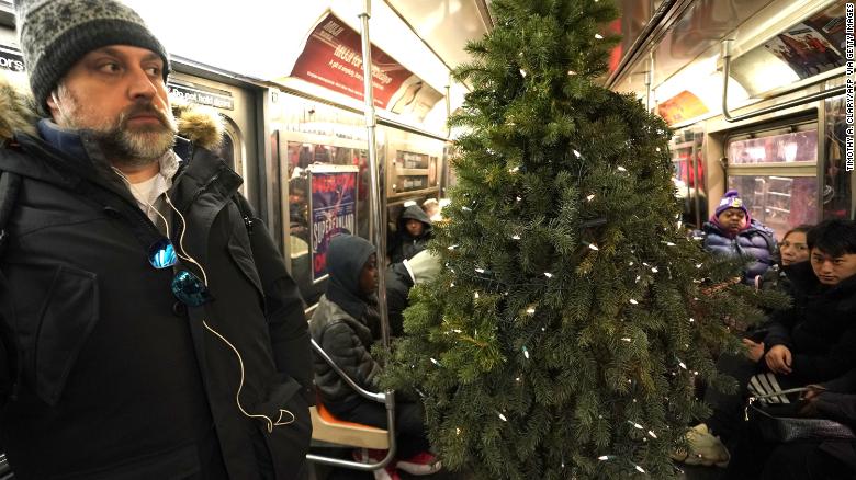 A man dressed up as a Christmas tree is walking around New York City