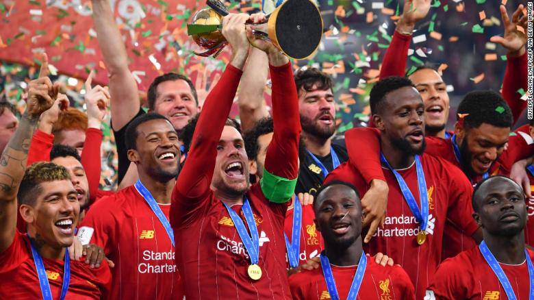 Liverpool captain Jordan Henderson lifts the Club World Cup trophy after his side&#39;s 1-0 extra time victory over Flamengo in Qatar.