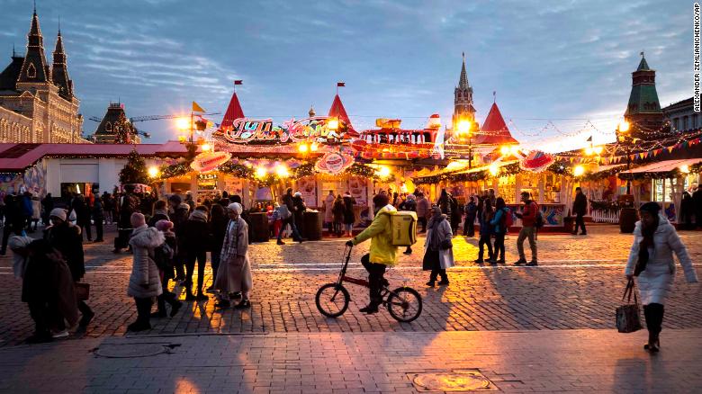 People walk at Holiday&#39;s Market on Red Square in Moscow on Friday, December 20. 