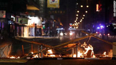 Debris burns on a street during the Christmas holiday in Hong Kong.