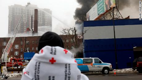 People displaced by the fire wait to hear news on their fate after a four-alarm fire at the Francis Drake Hotel apartments that broke out early Christmas morning.