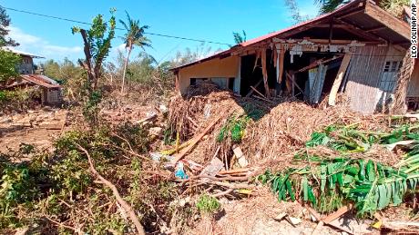 Debris from floods caused by Typhoon Phanfone surround a damaged house in Balasan Town, Iloilo province, on December 26, 2019.