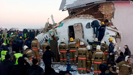 Police and rescue workers arrive at the site of the crash near Almaty International Airport, Kazakhstan, Friday, December 27, 2019.