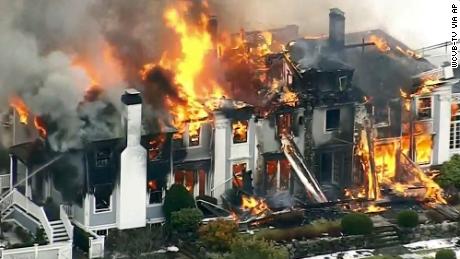 The 6,500-square-foot house was engulfed in flames as firefighters battled to bring it under control.