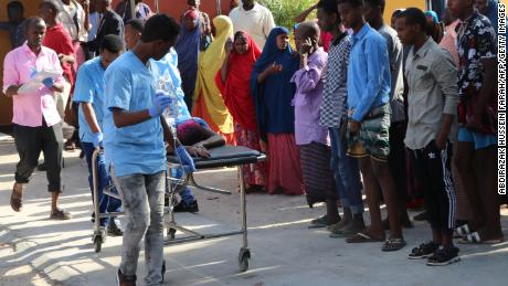 Nurses from Mogadishu&#39;s Madina Hospital push a wounded person on a stretcher.
