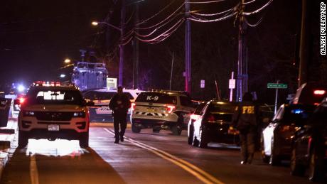 Authorities gather on a street in Monsey, N.Y., Sunday, Dec. 29, 2019, following a stabbing late Saturday during a Hanukkah celebration. A man attacked the celebration at a rabbi&#39;s home north of New York City late Saturday, stabbing and wounding several people before fleeing in a vehicle, police said. (AP Photo/Allyse Pulliam)