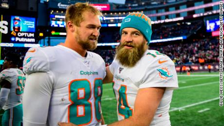 Mike Gesicki, left, and Ryan Fitzpatrick celebrate after defeating the Patriots.