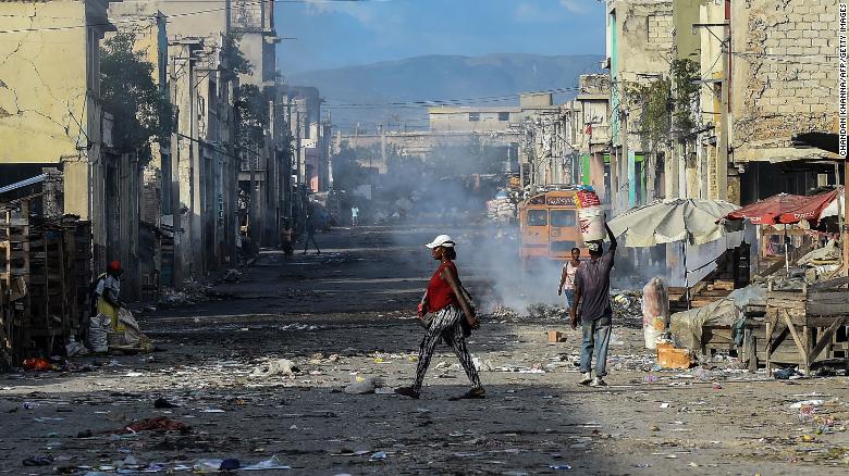 People walk in downtown  Port-au-Prince on December 20, 2019. The country's infrastructure remains in dire need of repair.