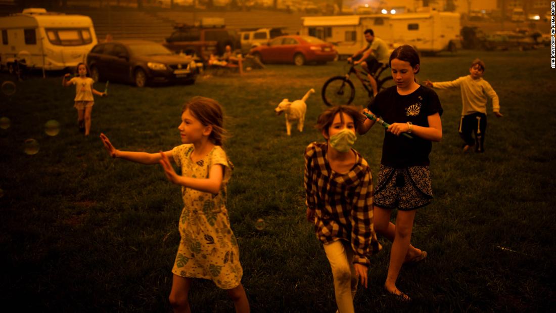 Children evacuated from areas affected by bushfires play at the showgrounds in the southern New South Wales town of Bega on December 31.