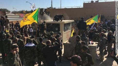 Iraqi protesters try to storm the US Embassy in Baghdad on Tuesday.