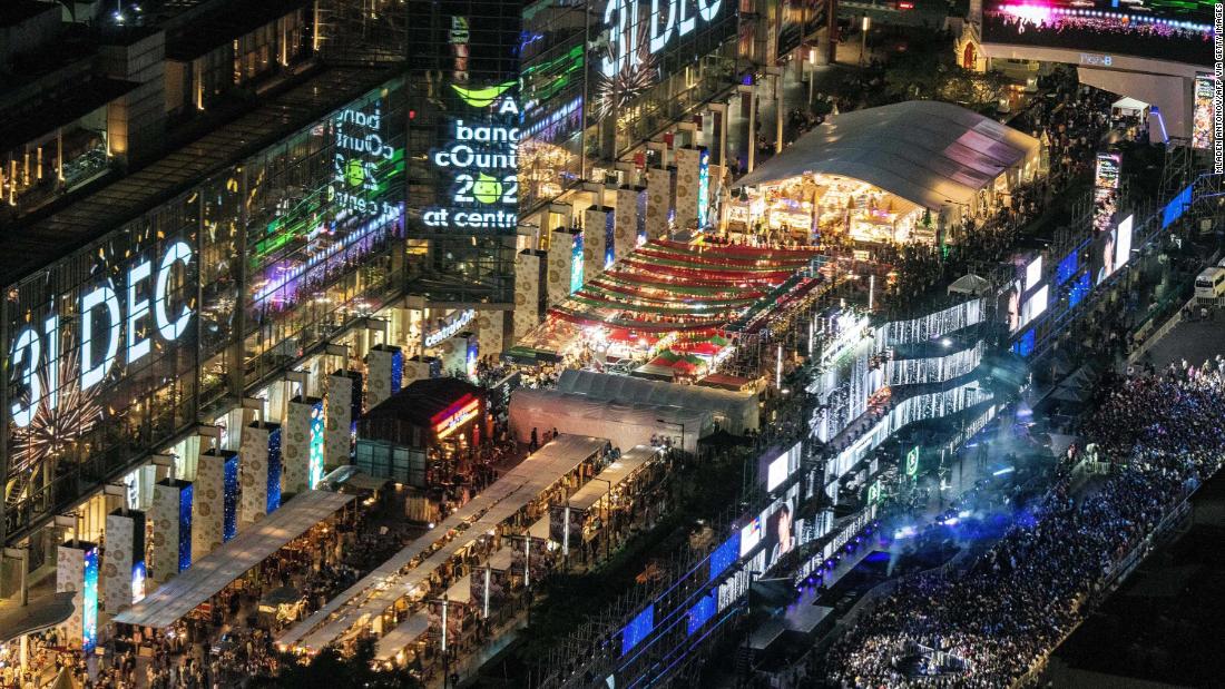 Revelers arrive to watch the New Year&#39;s Eve countdown outside a shopping mall in downtown Bangkok, Thailand.