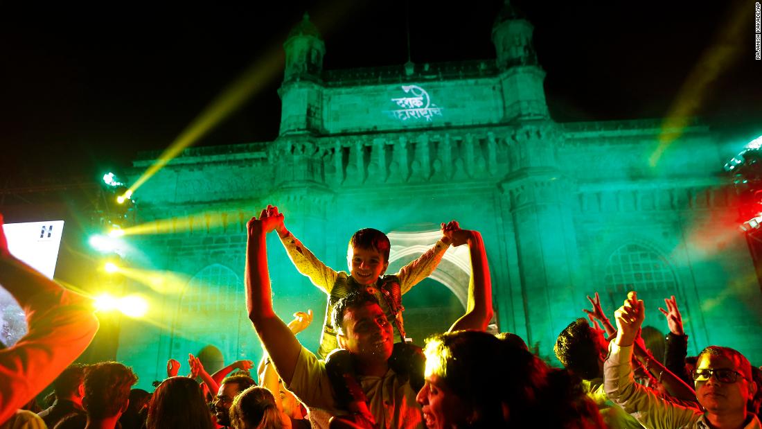 People celebrate New Year&#39;s Eve in front of the Gateway of India in Mumbai. 