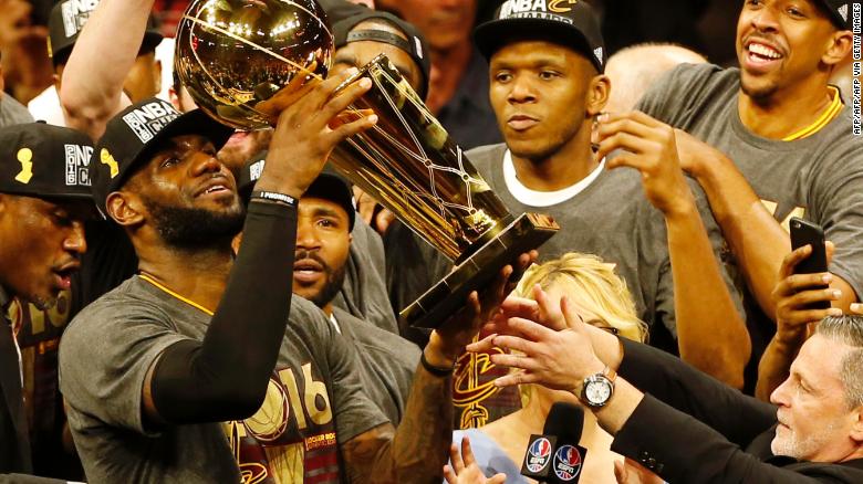 LeBron James hoists the Larry O&#39;Brien trophy after his Cleveland Cavaliers beat the Golden State Warriors to win the NBA Finals in 2016.