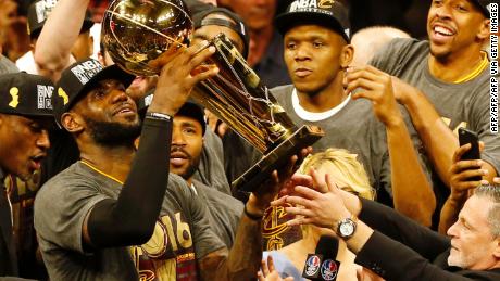 LeBron James hoists the Larry O&#39;Brien trophy after his Cleveland Cavaliers beat the Golden State Warriors to win the NBA Finals in 2016.