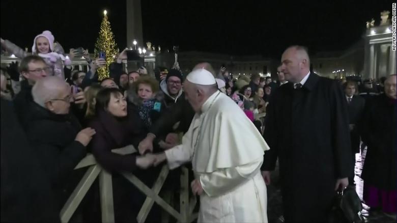 Pope Francis visibly annoyed after woman grabs him